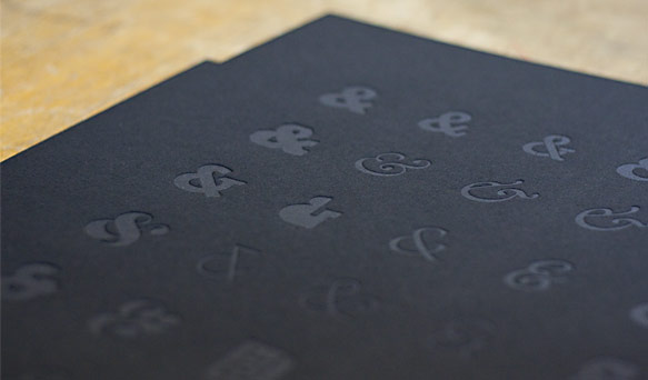 Letterpress printed ampersands in clear ink